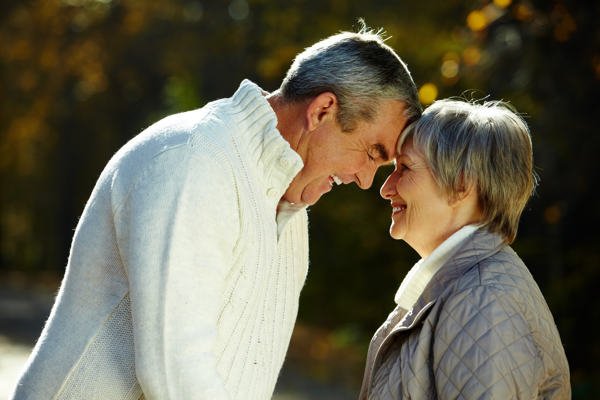 Photo of amorous senior couple in the park